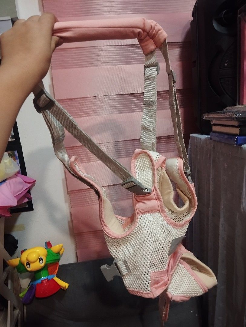 Pink and White Baby Walking Assistant Harness (Category: Infant Playtime) located in Taguig. Submitted by blairescloset (Listing ID 1470470558, Image 1). Description: - Color: Cute pink and white design - Breathable mesh fabric keeps your baby cool and comfortable - Adjustable straps ensure a secure fit as your toddler grows - Sturdy, secure buckles lock everything safely in place - Padded top handle allows for comfortable parent guidance during 