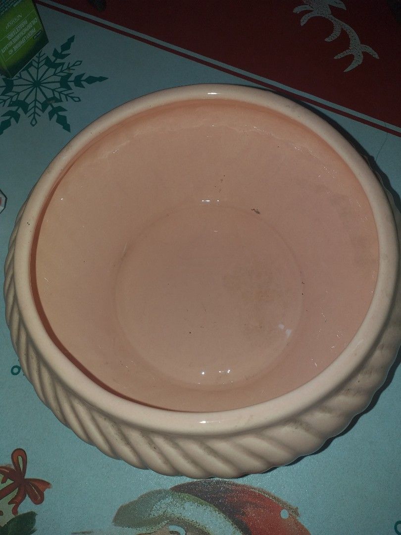 Pink ceramic ribbed plant pot (Category: Pots & Planters) located in Manila. Submitted by wisegem-231b (Listing ID 1470399566, Image 3). Description: - Color: Pale pink - Design: Diagonal ribbed texture with a wide opening and deep interior - Condition: Used with some faint marks on the side, but sturdy and sits flat - Perfect for: Planting your favorite greens or as a standalone home decor piece.