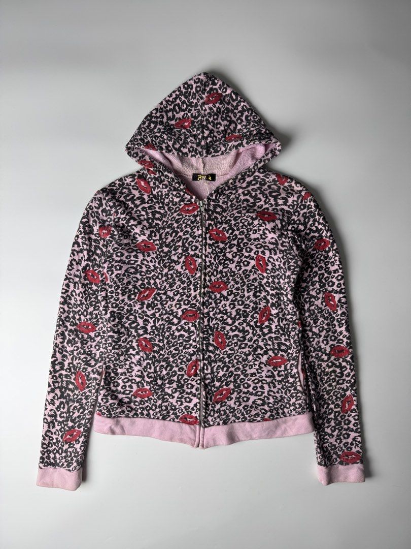 Pink Leopard Lips Zip-Up Hoodie (Category: Coats, Jackets and Outerwear) located in Manila. Submitted by babygirly2k (Listing ID 1470403596, Image 1). Description: - Style: Pink full-zip hoodie with black leopard print and red lips - Comfort: Soft, cozy interior lining with attached hood - Features: Convenient front pockets, ribbed pink cuffs and hem - Measurements: 17" pit-to-pit, 24" length, 25" sleeve length - Condition: Excellent find, perfec