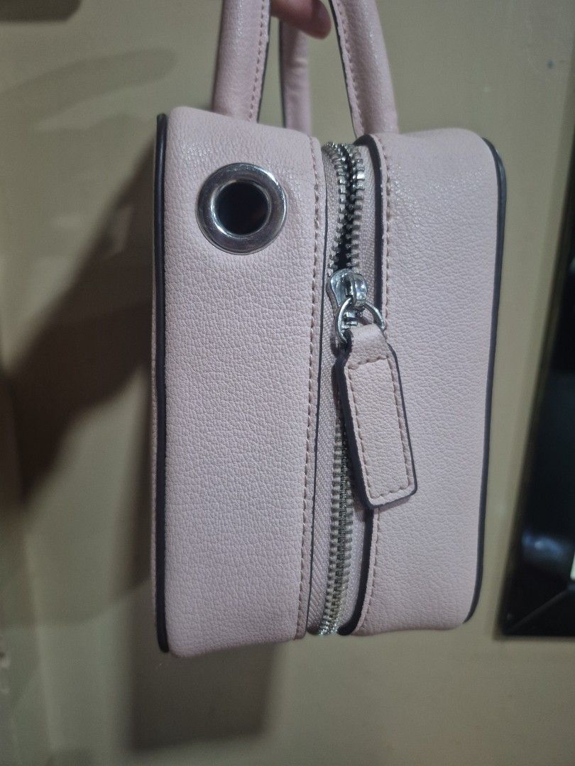 Pink structured mini handbag with top handles and zipper (Category: Luxury Bags & Wallets) located in Iloilo. Submitted by gorgeoustatz (Listing ID 1470416095, Image 3). Description: - Color: Light pink - Material: Clean faux leather - Hardware: Silver-tone zippers - Design: Structured and minimalist - Features: Dual top handles, protective metal feet on the bottom - Size: Compact, perfect for daily essentials FREE for at least 2K purchase.