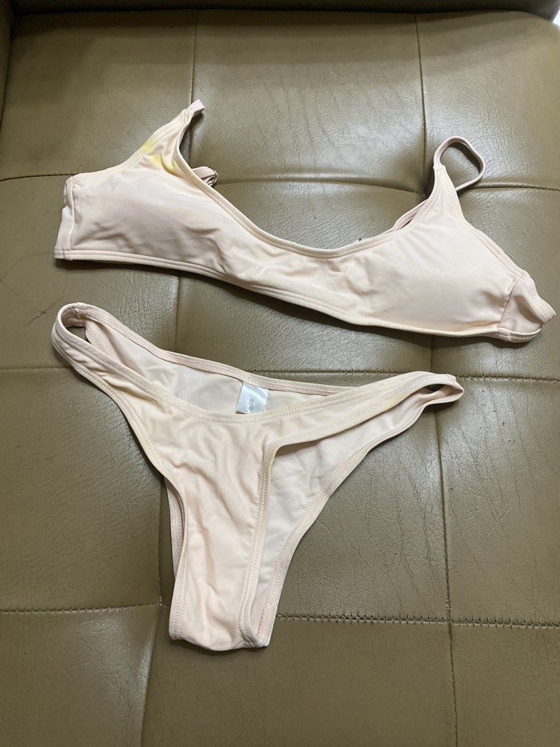 Pink two-piece bikini set size S (Category: Bikinis & Swimsuits) located in Batangas. Submitted by v.ukay (Listing ID 1470452391, Image 1). Description: - Style: Two-piece bikini set - Color: Light pink with white inner lining - Size: S (tag attached) - Features: Adjustable straps and secure back clasp - Condition: Pre-loved, with visible yellow discoloration and stains around the fabric and seams.