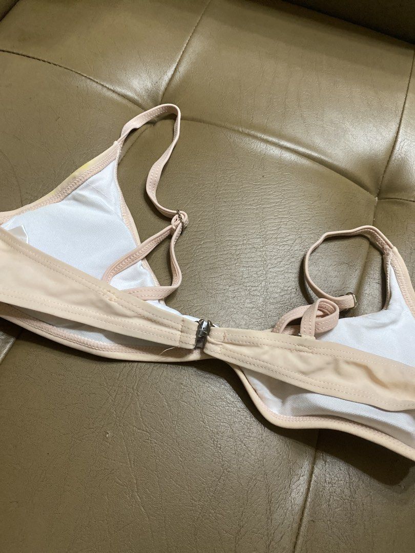 Pink two-piece bikini set size S (Category: Bikinis & Swimsuits) located in Batangas. Submitted by v.ukay (Listing ID 1470452391, Image 3). Description: - Style: Two-piece bikini set - Color: Light pink with white inner lining - Size: S (tag attached) - Features: Adjustable straps and secure back clasp - Condition: Pre-loved, with visible yellow discoloration and stains around the fabric and seams.