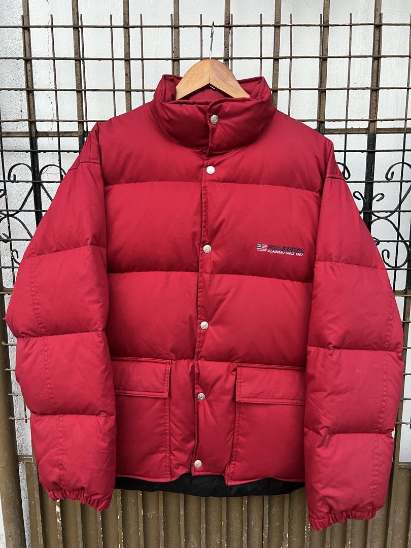 Polo Jeans Co. Ralph Lauren Red Puffer Jacket (Category: Coats, Jackets and Outerwear) located in Manila. Submitted by tomdenzell38299 (Listing ID 1470534830, Image 1). Description: - Brand: Polo Jeans Co. Ralph Lauren - Color: Bright red - Design: Embroidered US flag logo on the chest - Warmth: Thick quilted padding for heavy cold-weather protection - Collar: High stand-up collar with snap buttons over front zip - Pockets: Two lower front patch 