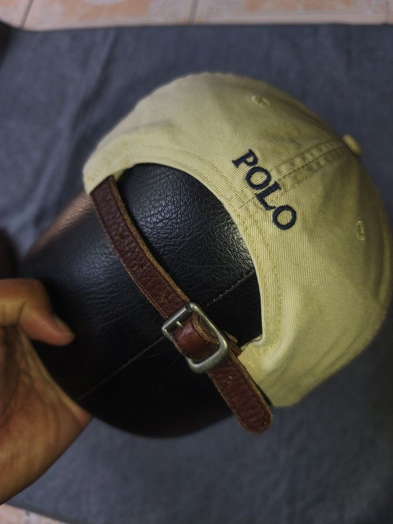 Polo Ralph Lauren Beige Cap with Leather Strap (Category: Caps & Hats) located in Cagayan de Oro. Submitted by adamfitz (Listing ID 1470484023, Image 3). Description: - Authentic Polo Ralph Lauren cap in versatile khaki beige - Premium cotton twill material with clean stitching - Iconic dark blue embroidered pony logo on the front - 'POLO' embroidery above the back strap - Adjustable brown leather strap with metal buckle for a custom fit osfm exc