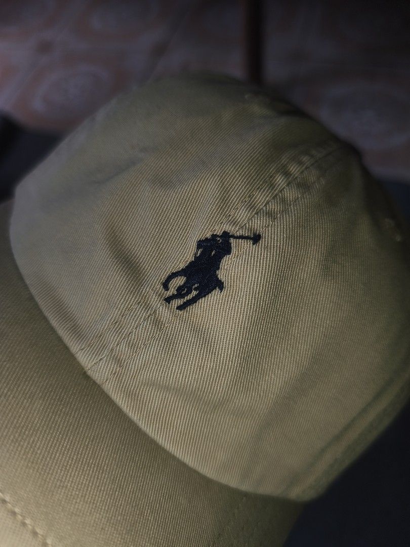 Polo Ralph Lauren Beige Cap with Leather Strap (Category: Caps & Hats) located in Cagayan de Oro. Submitted by adamfitz (Listing ID 1470484023, Image 2). Description: - Authentic Polo Ralph Lauren cap in versatile khaki beige - Premium cotton twill material with clean stitching - Iconic dark blue embroidered pony logo on the front - 'POLO' embroidery above the back strap - Adjustable brown leather strap with metal buckle for a custom fit osfm exc