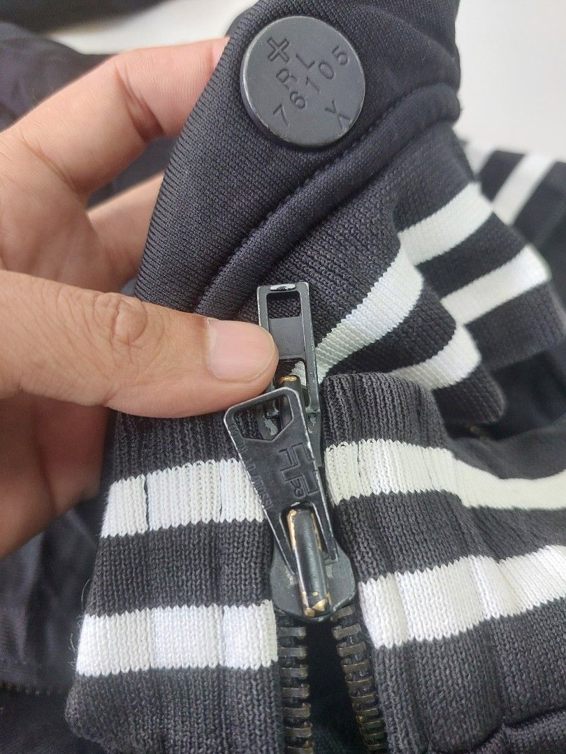 Polo Ralph Lauren Black Track Jacket Size M (Category: Coats, Jackets and Outerwear) located in Caloocan City. Submitted by shikiibun (Listing ID 1470490294, Image 3). Description: - Brand: Polo Ralph Lauren - Color: Black with white side stripes and details - Size: M - Material: 74% nylon, 26% cotton blend - Design: Full zip closure, ribbed collar, cuffs, and hem - Features: Two front pockets and a large crown graphic print on the front.