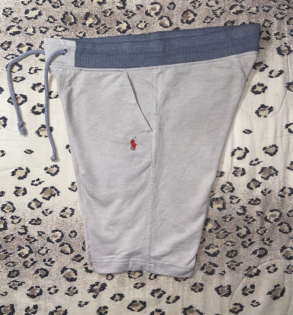 Polo Ralph Lauren grey drawstring sweat shorts size S (Category: Shorts) located in Manila. Submitted by nix.thrift (Listing ID 1470410694, Image 1). Description: - Brand: Polo Ralph Lauren - Color: Light grey with dark grey ribbed waistband - Size: S (tag attached) - Material: Soft and comfortable cotton blend - Details: Adjustable drawstring cords, small red embroidered pony logo on front left - Pockets: Two side slip pockets and one back right
