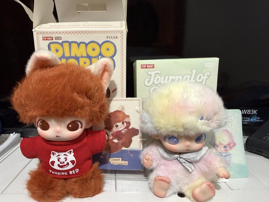 POP MART Dimoo World Plush Pendant Blind Box Figures (Category: Plushies & Soft Toys) located in Talisay. Submitted by grazelle_1985 (Listing ID 1470491822, Image 1). Description: - Set of 2 Pop Mart Dimoo World vinyl plush pendant blind box figures - Includes Red Panda Mei (in Turning Red shirt) and Pastel Rainbow plush - Comes with their original matching character cards and opened boxes - Perfect addition to any art toy or blind box collection