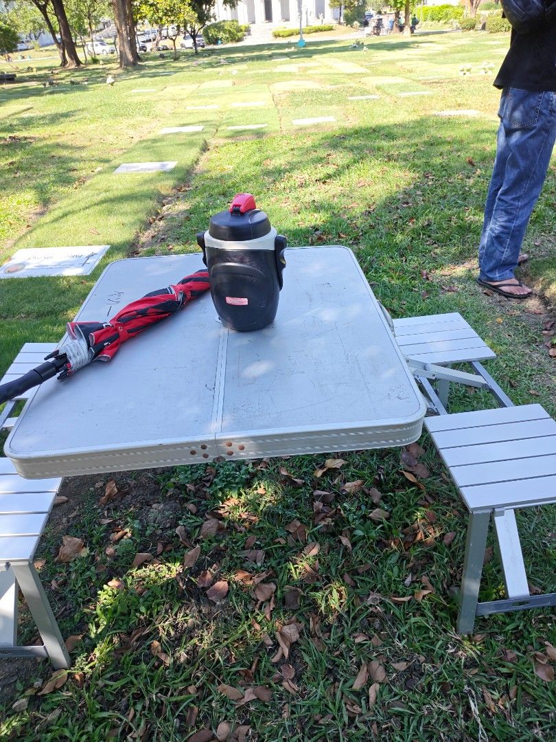 Portable Folding Picnic Table with Attached Seats (Category: Tables & Sets) located in Muntinlupa City. Submitted by jojiepogi123 (Listing ID 1470425963, Image 2). Description: - Portable aluminum picnic table with four attached folding seats - Folds into a compact briefcase case with a built-in carry handle for easy transport - Features a center hole to accommodate an outdoor umbrella - Lightweight design, quick and easy to set up - Ideal for ca