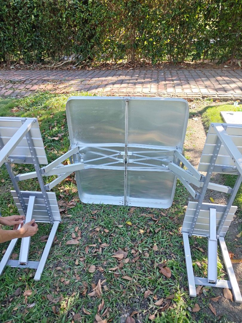 Portable Folding Picnic Table with Attached Seats (Category: Tables & Sets) located in Muntinlupa City. Submitted by jojiepogi123 (Listing ID 1470425963, Image 3). Description: - Portable aluminum picnic table with four attached folding seats - Folds into a compact briefcase case with a built-in carry handle for easy transport - Features a center hole to accommodate an outdoor umbrella - Lightweight design, quick and easy to set up - Ideal for ca