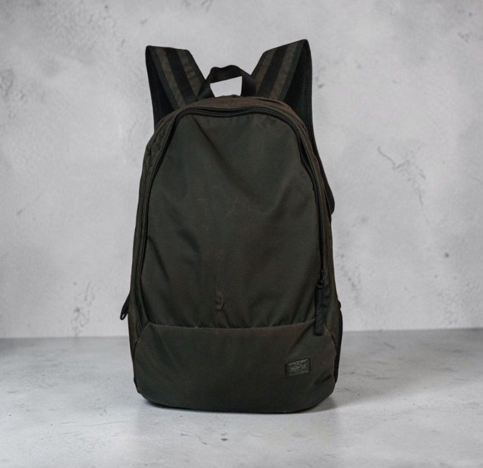 Porter - Yoshida Caban - Drive Daypack - Olive Green Nylon Backpack (Category: Backpacks) located in Manila. Submitted by grmnts_frmthe_slmz (Listing ID 1470396082, Image 1). Description: Porter Tokyo backpack from Japan. Classic black colorway. Durable nylon fabric with smooth zippers. Main compartment plus side mesh pockets. Padded shoulder straps for comfort. Clean interior lining. Small branded logo patch on the lower front. Great everyday ca