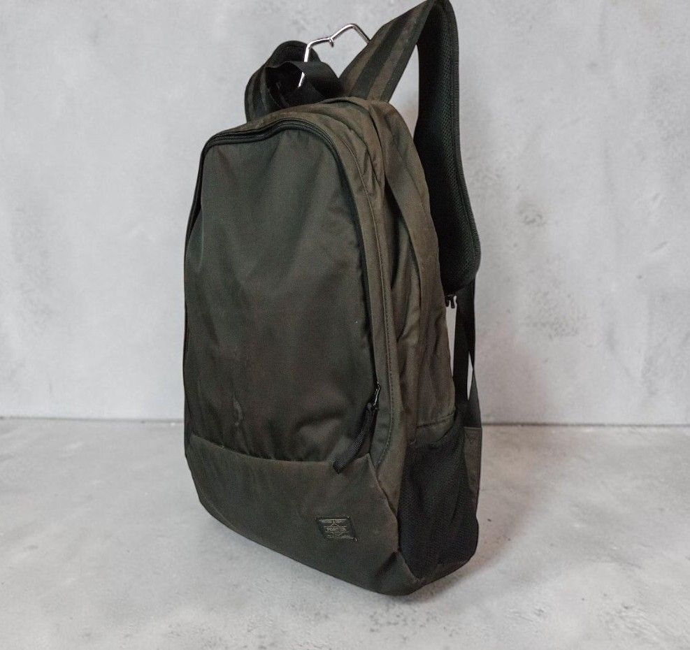Porter - Yoshida Caban - Drive Daypack - Olive Green Nylon Backpack (Category: Backpacks) located in Manila. Submitted by grmnts_frmthe_slmz (Listing ID 1470396082, Image 2). Description: Porter Tokyo backpack from Japan. Classic black colorway. Durable nylon fabric with smooth zippers. Main compartment plus side mesh pockets. Padded shoulder straps for comfort. Clean interior lining. Small branded logo patch on the lower front. Great everyday ca