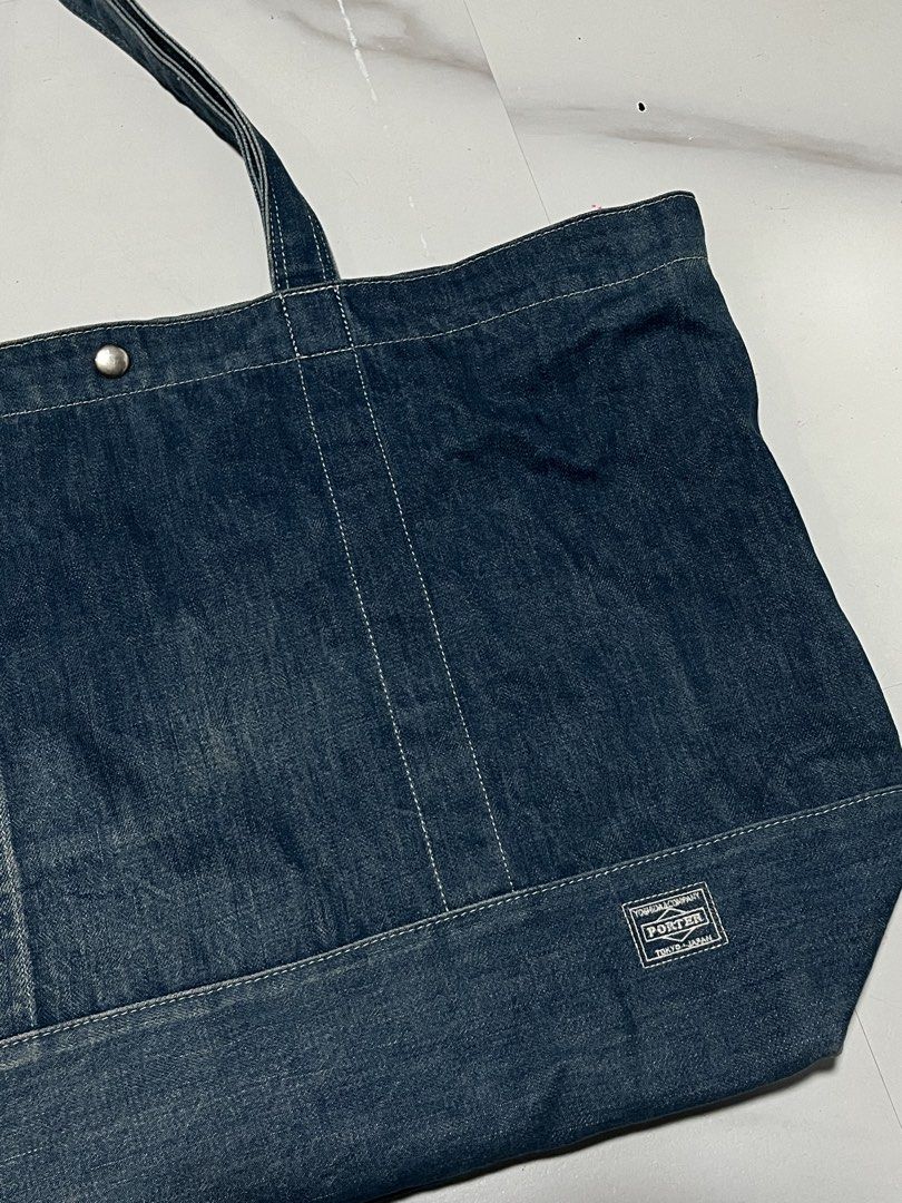 Porter Denim Tote Bag (Category: Tote Bags) located in Manila. Submitted by randomloots2 (Listing ID 1470461347, Image 2). Description: - Authentic Head Porter denim tote bag by Yoshida & Co (Made in Japan) - Crafted from sturdy denim with stylish contrast white stitching - Secure zip top closure with an additional snap button - Features multiple interior slip pockets for easy organization - Classic woven logo label on the front and branded inter