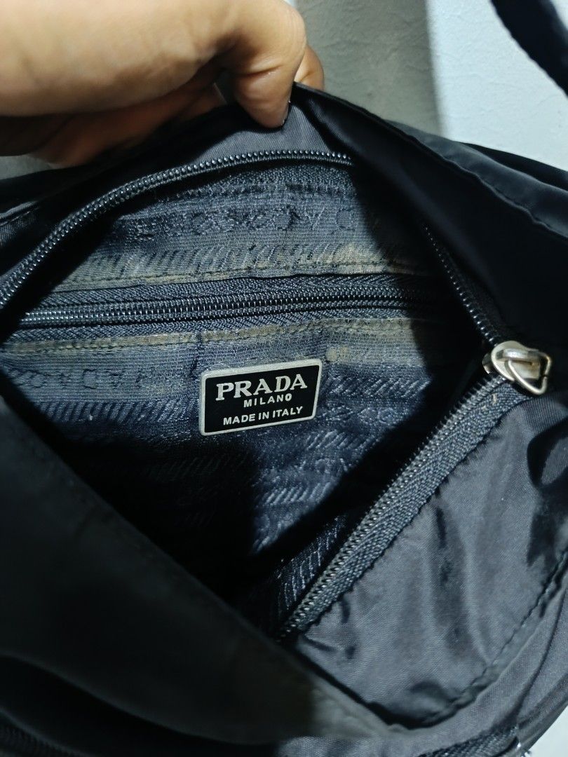 Prada Black Nylon Crossbody Messenger Bag (Category: Luxury Bags & Wallets) located in Manila. Submitted by nothingtosay_00 (Listing ID 1470357713, Image 2). Description: - Authentic Prada black nylon crossbody bag - Iconic enamel triangle logo plaque on the front flap - Adjustable shoulder strap for custom fit - Front flap with extra zipped pocket for easy access - Signature Prada logo-patterned interior lining - Internal zip pocket and official