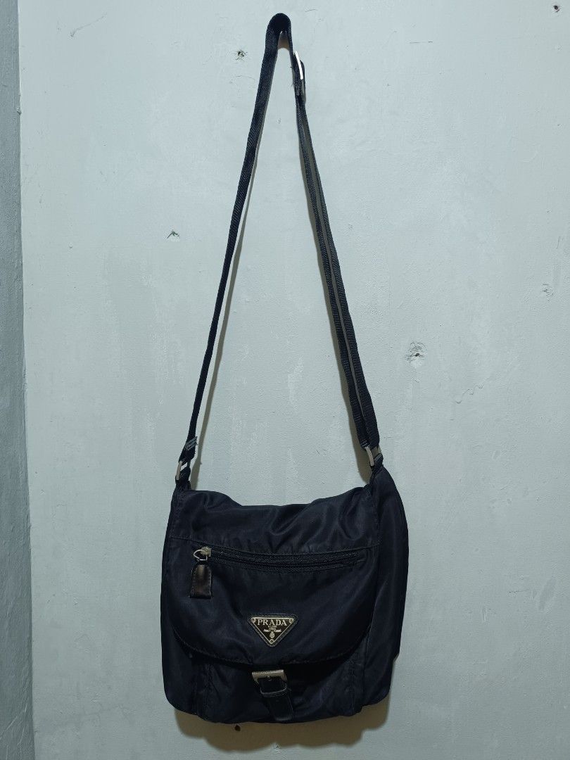 Prada Black Nylon Crossbody Messenger Bag (Category: Luxury Bags & Wallets) located in Manila. Submitted by nothingtosay_00 (Listing ID 1470357713, Image 1). Description: - Authentic Prada black nylon crossbody bag - Iconic enamel triangle logo plaque on the front flap - Adjustable shoulder strap for custom fit - Front flap with extra zipped pocket for easy access - Signature Prada logo-patterned interior lining - Internal zip pocket and official