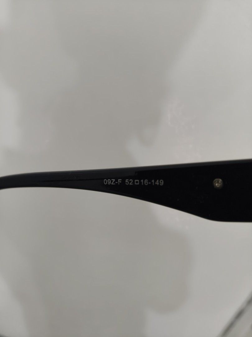 Prada Black Optical Glasses Frame 09Z-F (Category: Sunglasses & Eyewear) located in Davao. Submitted by navil01 (Listing ID 1470403845, Image 3). Description: - Brand: Prada - Color: Glossy black with gold hardware - Model & Size: 09Z-F, 52-16-149 - Features: Iconic gold triangular logo on both temples, chunky statement browline - Origin: Made in Italy - Lenses: Clear demonstration lenses with Prada branding (ready for your custom prescription) -
