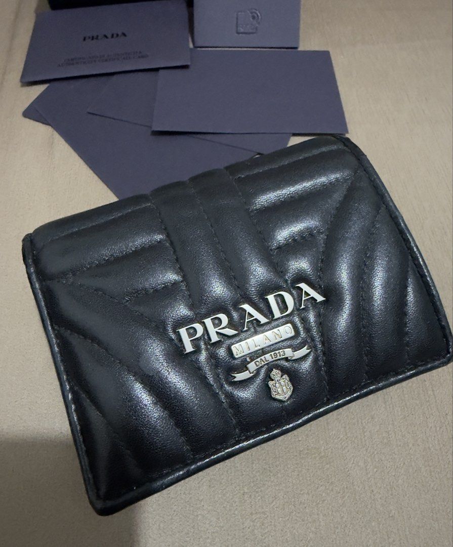 Prada Diagramme Bifold Wallet (RFID VERSION) (Category: Luxury Bags & Wallets) located in Valenzuela. Submitted by eande_manila (Listing ID 1470548076, Image 2). Description: Rank A+ In excellent condition No flaws, only minimal creasing on the inside Comes with box, card, rfid and LegitGrails 100% authentic.