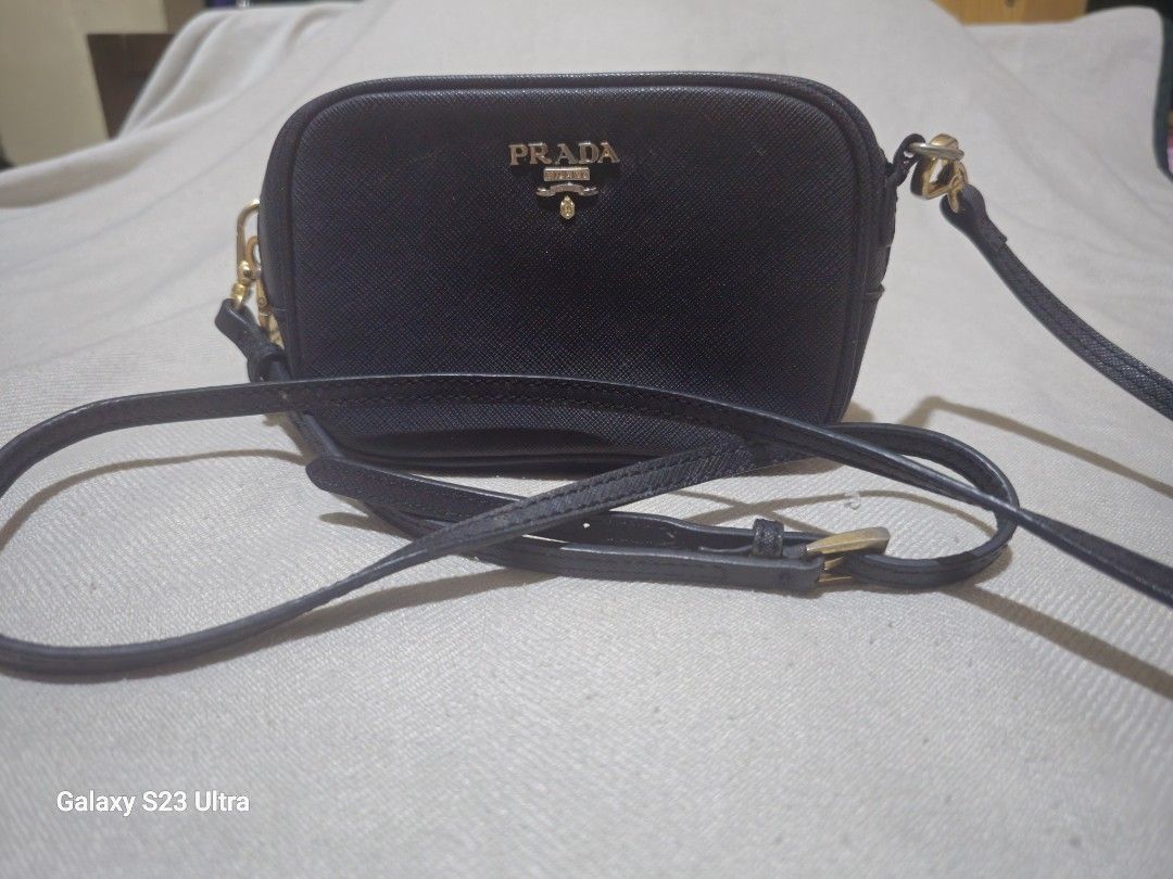 Prada Mini Saffiano Leather Crossbody Bag (Category: Cross-body Bags) located in Quezon City. Submitted by bagsforless16 (Listing ID 1470512044, Image 1). Description: Rare Authentic Mini Prada Saffiano Leather Camera Crossbody Bag Good Condition Gold Hardware with Prada Logo Lining with Embossed Prada Logo Saffiano Leather Strap For Daily Essentiaks .