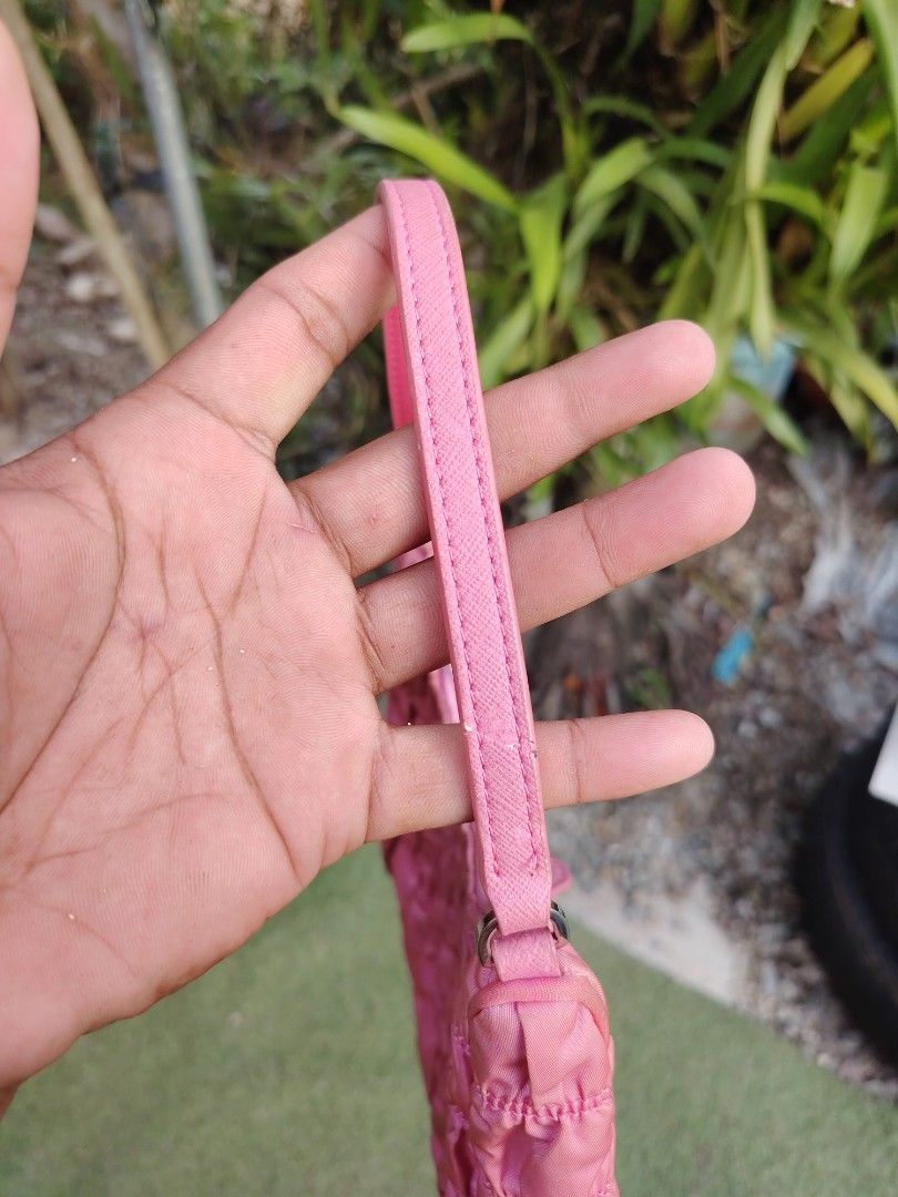 Prada Pink Ruched Nylon Shoulder Bag (Category: Luxury Bags & Wallets) located in Roxas City. Submitted by bawalthrift (Listing ID 1470431335, Image 1). Description: - Prada ruched nylon shoulder bag in a stunning pink shade - Silver-tone hardware and durable pink Saffiano leather strap - Secure top zip closure with branded metal zipper pull - Luxurious purple jacquard logo interior lining with Prada metal plaque - Features the iconic pink enamel