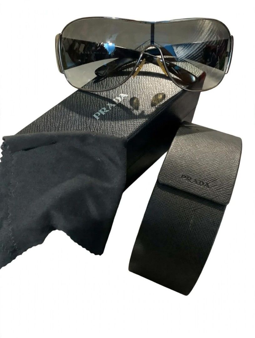 Prada SPR 57L Sunglasses (Category: Sunglasses & Eyewear) located in Manila. Submitted by clevershark.f2840d (Listing ID 1470543607, Image 1). Description: - Brand: Prada - Model: SPR 57L 7ZO-3M1 120 2N - Design: Sleek dark frames with stylish gradient lenses - Condition: Minimal wear on hardware and lenses, excellent everyday pair - Inclusions: Original black Saffiano leather hard case, matching cleaning cloth, and outer box - Trusted seller: Bu