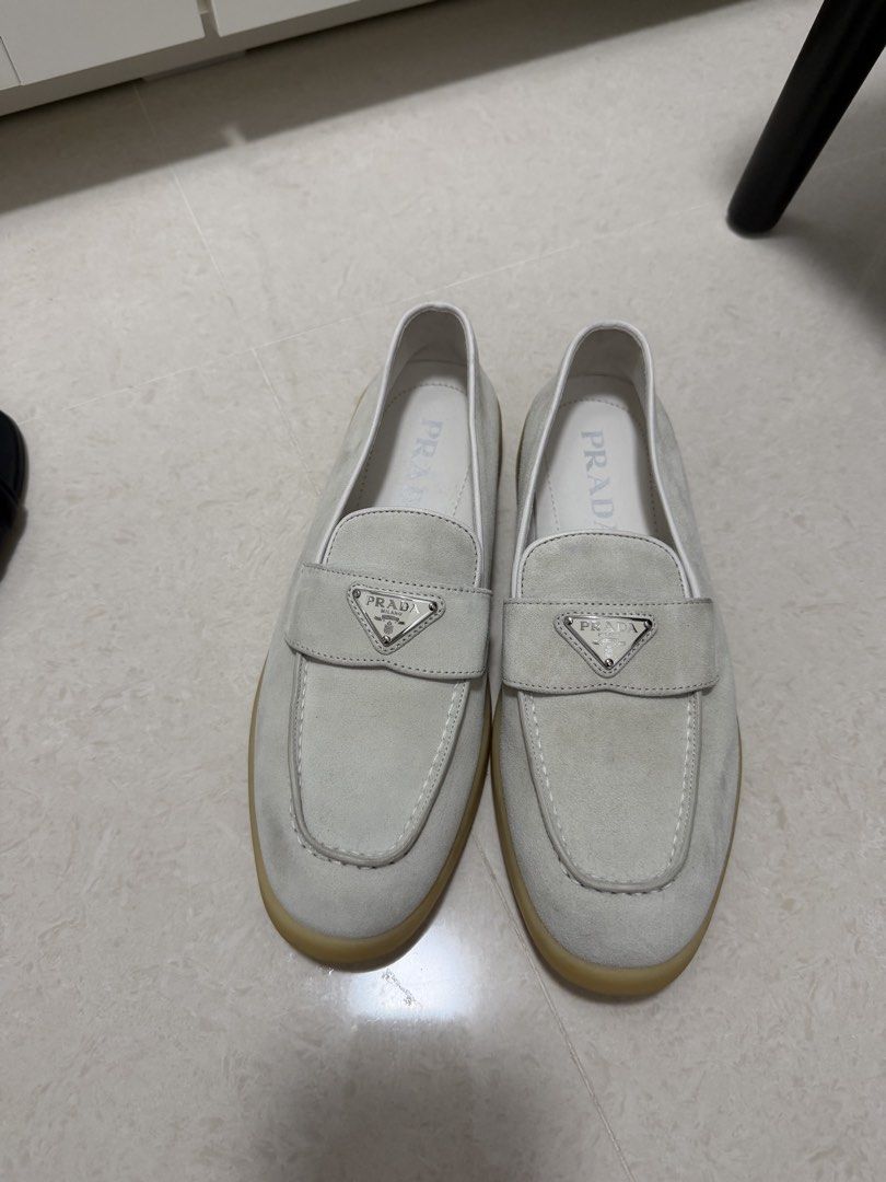 Prada Suede Loafers White Size 38 (Category: Loafers) located in Cavite. Submitted by villary (Listing ID 1470413248, Image 1). Description: - Brand: Prada 100% legit - Item: Suede Loafers - Color: White - Size: 38 (marked on inner side) - Material: Premium suede with gum rubber soles - Features: Iconic metal triangle logo plaque on front strap, embossed Prada lettering on back heel - Origin: Made in Italy - Condition: Clean overall with minimal 