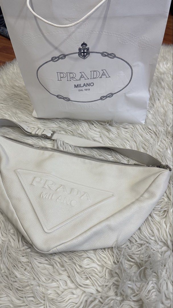 Prada Triangle Cross Body Bag (Category: Cross-body Bags) located in Manila. Submitted by mamk0823 (Listing ID 1470433933, Image 1). Description: - No more Prada dust bag and cards BUT we can provide a different dust bag and Prada Paper Bag - Has minor marks - Color: OFF WHITE.