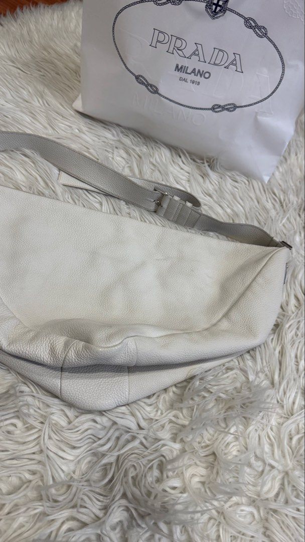 Prada Triangle Cross Body Bag (Category: Cross-body Bags) located in Manila. Submitted by mamk0823 (Listing ID 1470433933, Image 3). Description: - No more Prada dust bag and cards BUT we can provide a different dust bag and Prada Paper Bag - Has minor marks - Color: OFF WHITE.