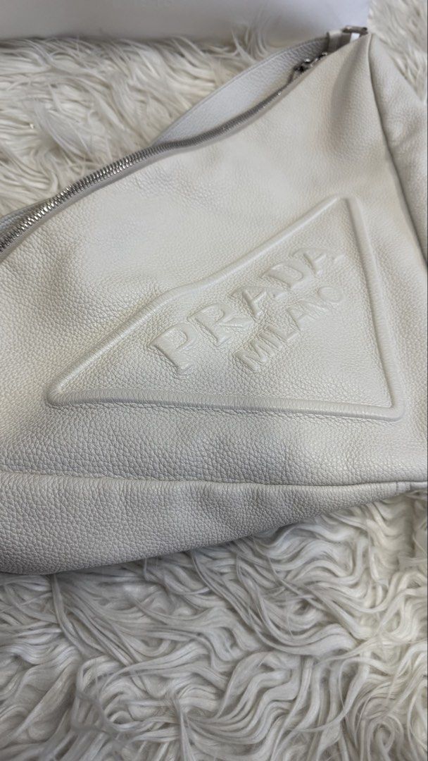 Prada Triangle Cross Body Bag (Category: Cross-body Bags) located in Manila. Submitted by mamk0823 (Listing ID 1470433933, Image 2). Description: - No more Prada dust bag and cards BUT we can provide a different dust bag and Prada Paper Bag - Has minor marks - Color: OFF WHITE.