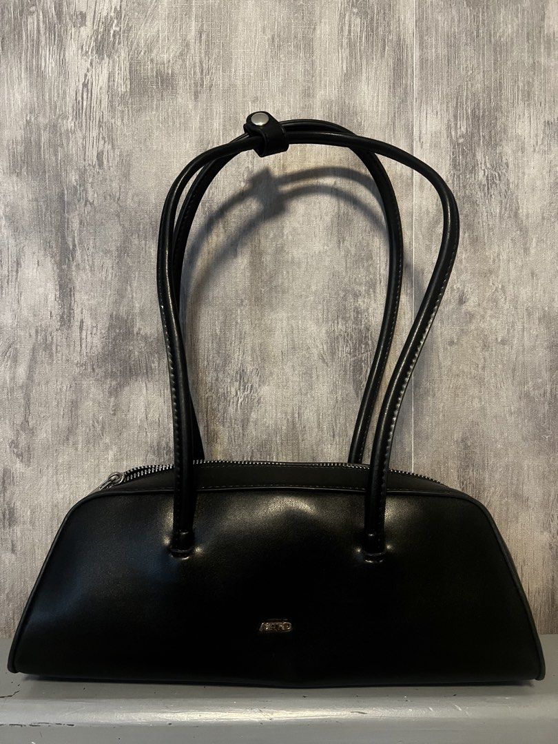Preloved bags (Category: Cross-body Bags) located in Calamba. Submitted by saiphsavion (Listing ID 1470455448, Image 1). Description: Black Charles & Keith shoulder bag. Structured silhouette with gold-tone hardware. Thick chain straps threaded with black material wrap around the sides. Flap closure on the front with gold lettering branding. Smooth faux leather material. Compact size for daily essentials, evening out, or casual errands..
