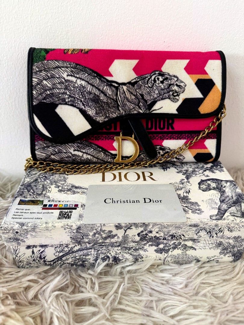 Preloved Dio bag shoulder with chain (Category: Shoulder Bags) located in Caloocan City. Submitted by mylove326 (Listing ID 1470420116, Image 1). Description: - Eye-catching bright pink, black, and white animal and geometric print - Signature gold-tone 'D' front closure - Chic chain strap for shoulder wear - Practical interior with card slots and zippered compartment - Includes matching patterned box and authentication card - perfect for making a