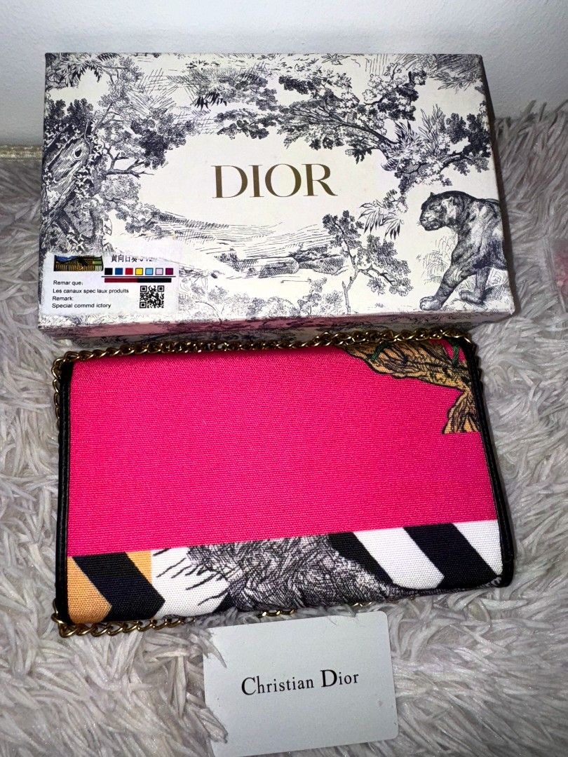 Preloved Dio bag shoulder with chain (Category: Shoulder Bags) located in Caloocan City. Submitted by mylove326 (Listing ID 1470420116, Image 2). Description: - Eye-catching bright pink, black, and white animal and geometric print - Signature gold-tone 'D' front closure - Chic chain strap for shoulder wear - Practical interior with card slots and zippered compartment - Includes matching patterned box and authentication card - perfect for making a