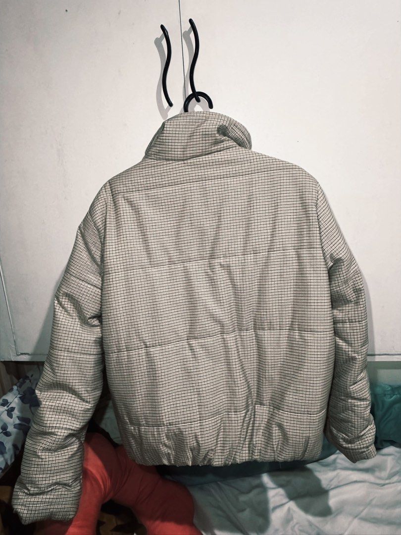 present.by Houndstooth Puffer Jacket Winter Coat (Category: Coats, Jackets and Outerwear) located in Dasmarinas. Submitted by ohfelicityshiz (Listing ID 1470469285, Image 2). Description: - Brand/Model: PRESENT.BY Puffer Jacket - Pattern: Classic beige and black houndstooth check - Features: High collar, full zip closure with snap button flap, elastic hem - Details: Decorative leather patch on the right arm and white inner collar lining - Conditi