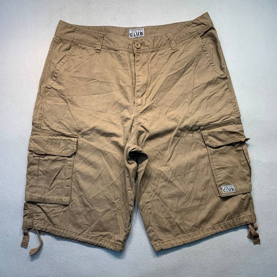 Pro Club Cargo Shorts Brown (Category: Shorts) located in Mandaluyong City. Submitted by theroom501 (Listing ID 1470514929, Image 1). Description: Pro Club Cargo Shorts Khaki Style Code: RN#100418 Size on Tag: 38 Color: Khaki Condition: Good pre-owned condition with a heavily distressed vintage look. Authenticity Flaws/Issues: Visible bleach stains on the fabric. Flat Lay Measurements: Pit to Pit: 38 inches Length: 26 inches Leeg opening Length: 