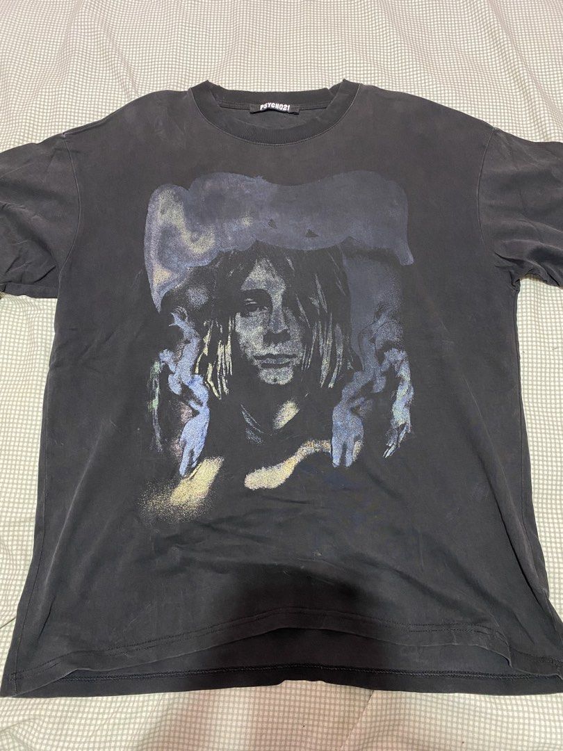PSYCHO21 Kurt Cobain Graphic Tee Black (Category: Tshirts & Polo Shirts ) located in Manila. Submitted by warmmountain-f38a (Listing ID 1470449076, Image 1). Description: - Brand: PSYCHO21 - Design: Large faded Kurt Cobain front graphic with Nirvana back text - Style: Heavy wash vintage/distressed look with a crew neckline and relaxed fit - Size: Large - Condition: Excellent pre-loved condition with no noticeable holes or tears.