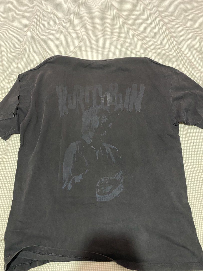 PSYCHO21 Kurt Cobain Graphic Tee Black (Category: Tshirts & Polo Shirts ) located in Manila. Submitted by warmmountain-f38a (Listing ID 1470449076, Image 2). Description: - Brand: PSYCHO21 - Design: Large faded Kurt Cobain front graphic with Nirvana back text - Style: Heavy wash vintage/distressed look with a crew neckline and relaxed fit - Size: Large - Condition: Excellent pre-loved condition with no noticeable holes or tears.