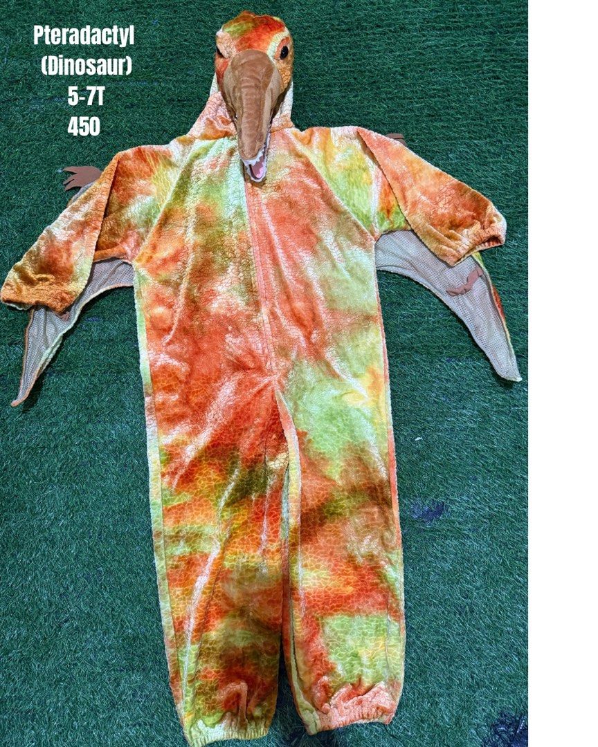 Pterodactyl Dinosaur Costume 5-7T (Category: Babies & Kids Fashion) located in San Fernando. Submitted by InvisibleMe (Listing ID 1470452263, Image 1). Description: - Size: Kids 5-7T - Design: Bright orange and green with attached arm wings - Hood: Detailed padded Pterodactyl head and beak - Closure: Convenient front zipper for easy wear - Material: Soft and comfortable fabric.