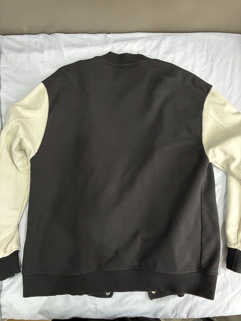 Pull & Bear Black and White Varsity Jacket (Category: Coats, Jackets and Outerwear) located in Manila. Submitted by nikkoour (Listing ID 1470408408, Image 2). Description: - Color: Black body with contrasting cream sleeves - Material: Comfortable cotton-poly blend - Design: Snap button closure, ribbed cuffs/hem, two side pockets with white trim - Feature: Large embroidered "PB" patch on the left chest (plain black back) - Condition: Clean overall