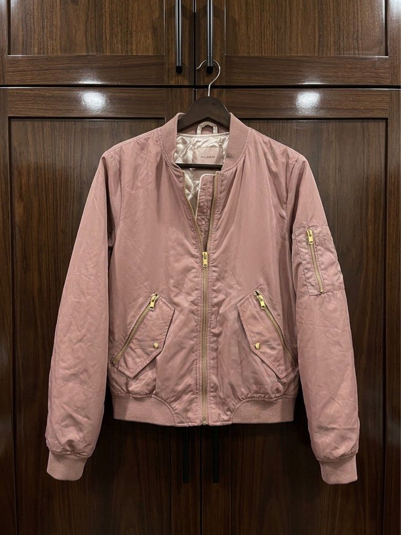 Pull & Bear Pink Bomber Jacket EUR M (Category: Coats, Jackets and Outerwear) located in Marikina City. Submitted by sakura_07 (Listing ID 1470398364, Image 1). Description: - Brand: Pull & Bear - Style: Bomber jacket in a trendy dusty pink shade - Size: EUR M / MEX 28 - Lining: Cozy quilted interior - Hardware: Chic gold-tone zippers on the front, pockets, and left sleeve - Details: Ribbed collar, cuffs, and hem for a snug fit - Origin: Made in 