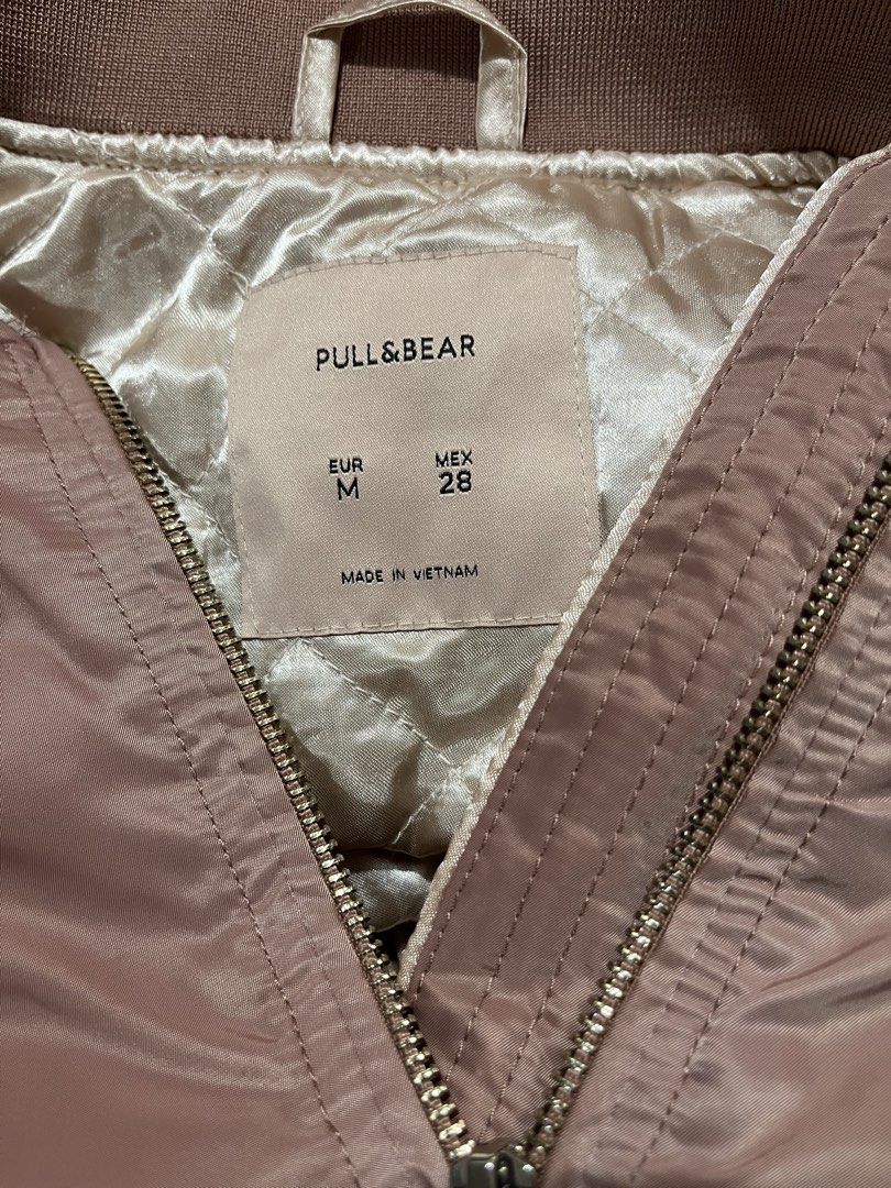 Pull & Bear Pink Bomber Jacket EUR M (Category: Coats, Jackets and Outerwear) located in Marikina City. Submitted by sakura_07 (Listing ID 1470398364, Image 2). Description: - Brand: Pull & Bear - Style: Bomber jacket in a trendy dusty pink shade - Size: EUR M / MEX 28 - Lining: Cozy quilted interior - Hardware: Chic gold-tone zippers on the front, pockets, and left sleeve - Details: Ribbed collar, cuffs, and hem for a snug fit - Origin: Made in 