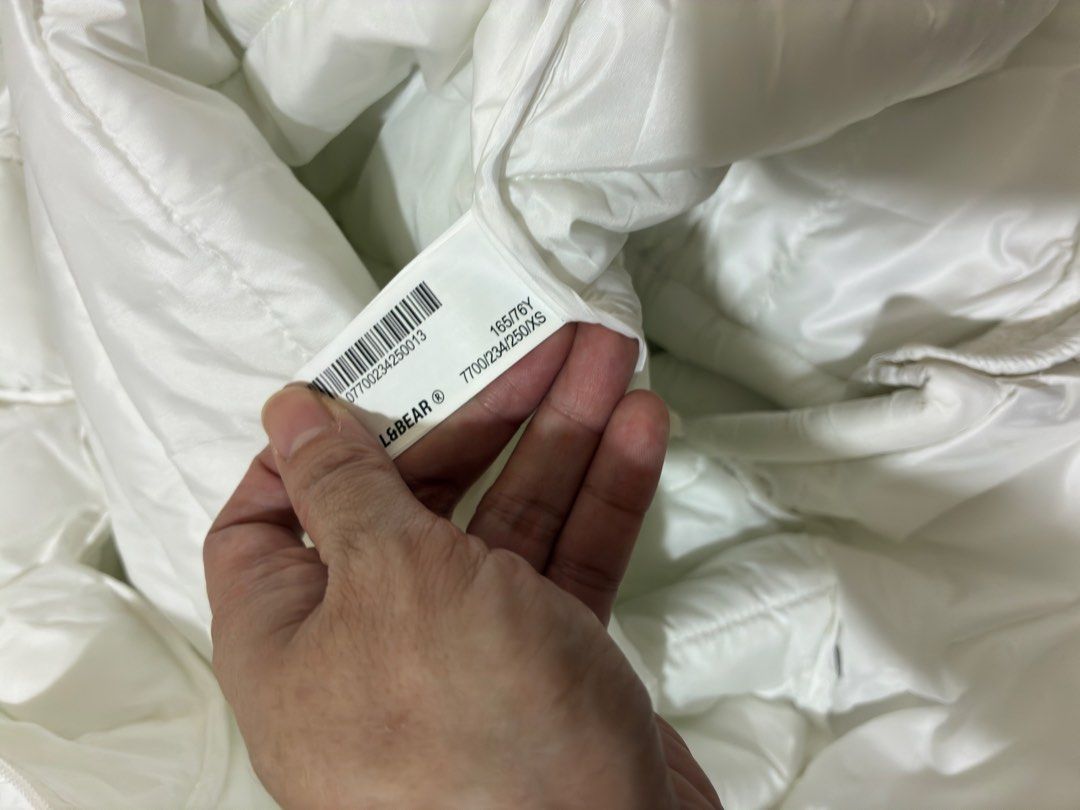 Pull&Bear White Puffer Jacket with Hood XS (Category: Coats, Jackets and Outerwear) located in Mandaluyong City. Submitted by littlecatstore (Listing ID 1470370790, Image 3). Description: - Brand: Pull&Bear - Style: White hooded puffer jacket - Size: XS (fits true to size) - Features: Zip-up front, quilted design, adjustable hem drawstrings - Condition: Clean white color, no stains or flaws - Perfect lightweight winter layer for everyday wear.