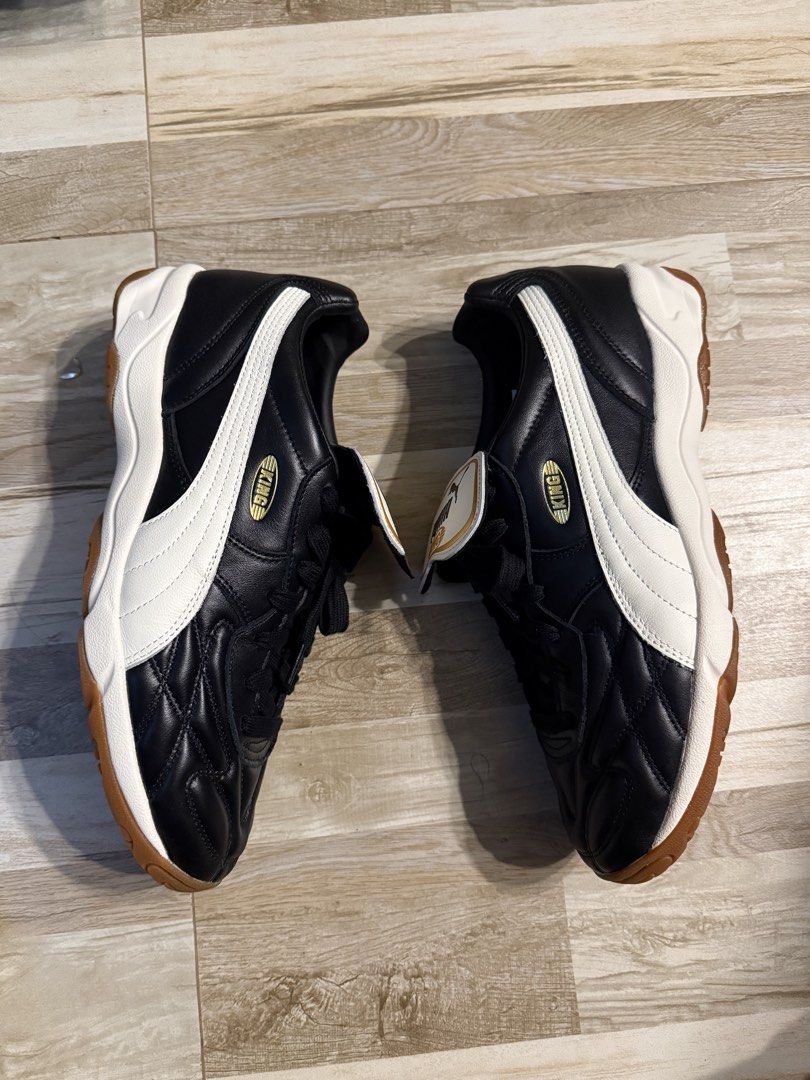 Puma King Indoor US 11 (Category: Sneakers) located in Manila. Submitted by safeowl.b6dbb0 (Listing ID 1470548831, Image 2). Description: - Brand/Model: Puma King Indoor Soccer Shoes - Colorway: Black and white with gold accents - Size: US 11.5 / UK 10.5 / EUR 45 / CM 29.5 - Material: Premium leather upper with quilted toe box stitching - Sole: Non-marking gum rubber outsole with great indoor traction - Key Feature: Iconic classic fold-over tongu