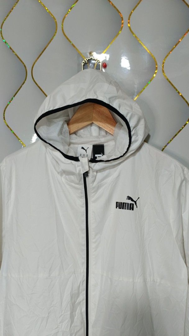 Puma White Hooded Windbreaker Jacket (Category: Coats, Jackets and Outerwear) located in Manila. Submitted by zariyah.1986 (Listing ID 1470463042, Image 2). Description: - Brand: Puma - Item: Hooded windbreaker jacket - Color: White with black zip and trim details - Size: XL (Tag measurements: 24" width x 25" length) - Condition: Lightweight layer, great for daily wear - Features: Full zip closure, adjustable hood, breathable mesh interior lining