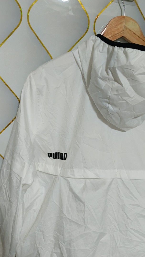 Puma White Hooded Windbreaker Jacket (Category: Coats, Jackets and Outerwear) located in Manila. Submitted by zariyah.1986 (Listing ID 1470463042, Image 3). Description: - Brand: Puma - Item: Hooded windbreaker jacket - Color: White with black zip and trim details - Size: XL (Tag measurements: 24" width x 25" length) - Condition: Lightweight layer, great for daily wear - Features: Full zip closure, adjustable hood, breathable mesh interior lining