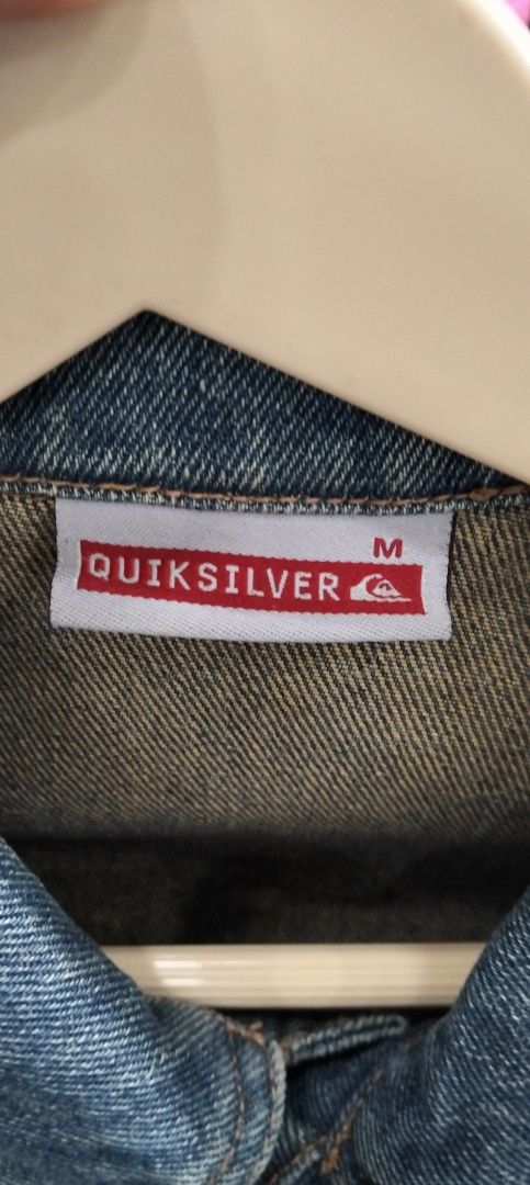 Quiksilver Denim Jacket Size M Vintage Blue (Category: Coats, Jackets and Outerwear) located in Bacolod City. Submitted by hurleydediamante0513 (Listing ID 1470377759, Image 2). Description: - Brand: Quiksilver - Style: Vintage denim jacket, solid streetwear piece - Color: Blue - Material: Cotton - Size: M on tag (fits chest size 95cm) - Features: Classic button-up front, chest flap pockets, graphic print, and embroidered branding patch on the ba