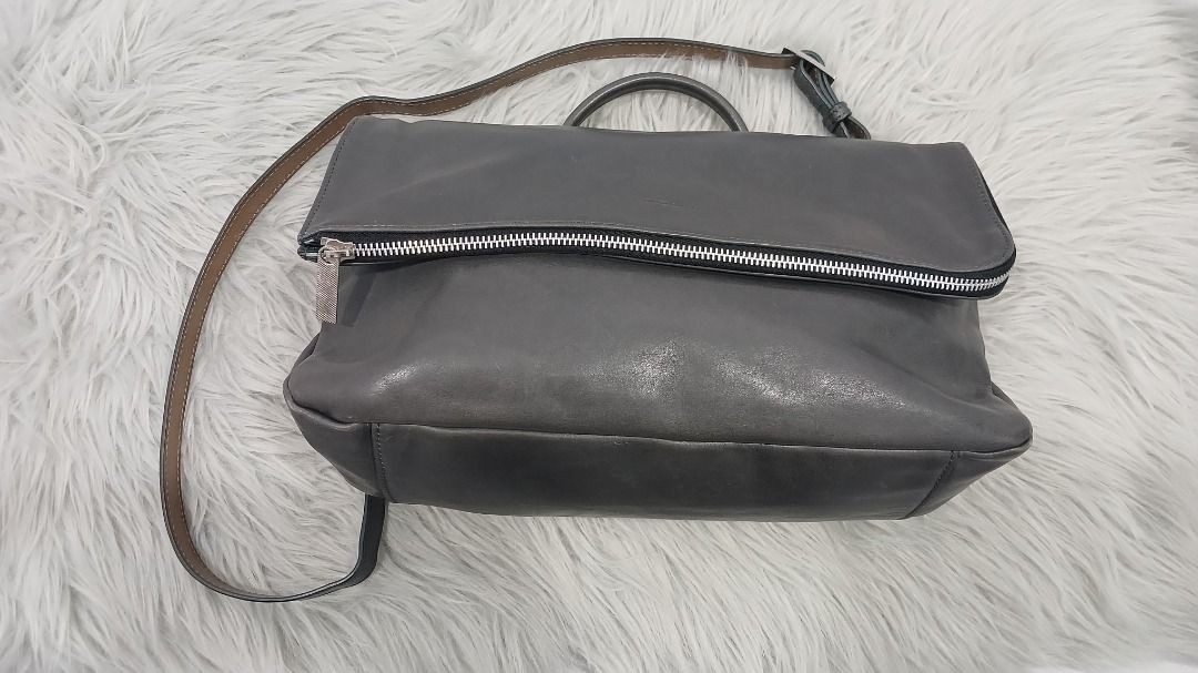 Rabeanco leather foldover crossbody bag (Category: Backpacks) located in Pasig City. Submitted by chinTM (Listing ID 1470364061, Image 2). Description: - Color: Dark Grey - Material: Soft, genuine leather - Style: 3-way wear (top handle, crossbody, or shoulder bag) - Design: Foldover flap - Hardware: Stylish silver-tone accents - Features: Comfortable top handle for easy grab-and-go. With a detachable, adjustable strap. Spacious interior with a z