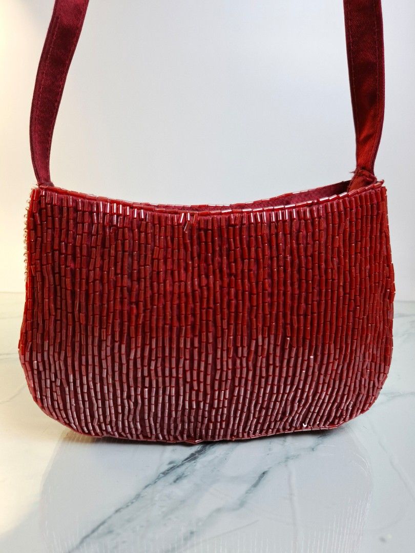 Red Beaded Shoulder Bag (Category: Shoulder Bags) located in Pasay City. Submitted by onick_79 (Listing ID 1470407204, Image 2). Description: - Dimensions: L 8 x H 12 x W 5cm Shoulder Drop: 20 cm -Stunning red beaded handbag with a chic structured shape - Fully covered in sparkling tiny red bugle beads - Comfortable satin shoulder straps - Secure zipper closure for the main compartment - Fabric interior lining - Perfect size for your phone, keys,