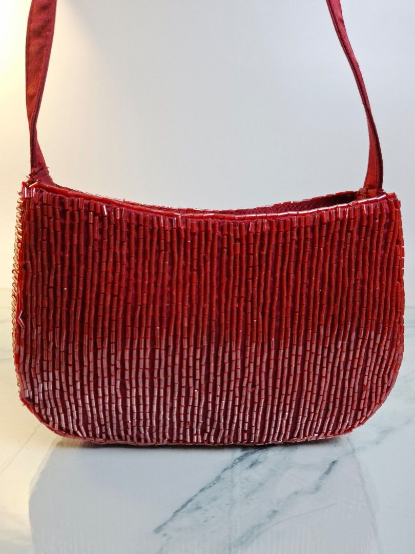 Red Beaded Shoulder Bag (Category: Shoulder Bags) located in Pasay City. Submitted by onick_79 (Listing ID 1470407204, Image 3). Description: - Dimensions: L 8 x H 12 x W 5cm Shoulder Drop: 20 cm -Stunning red beaded handbag with a chic structured shape - Fully covered in sparkling tiny red bugle beads - Comfortable satin shoulder straps - Secure zipper closure for the main compartment - Fabric interior lining - Perfect size for your phone, keys,
