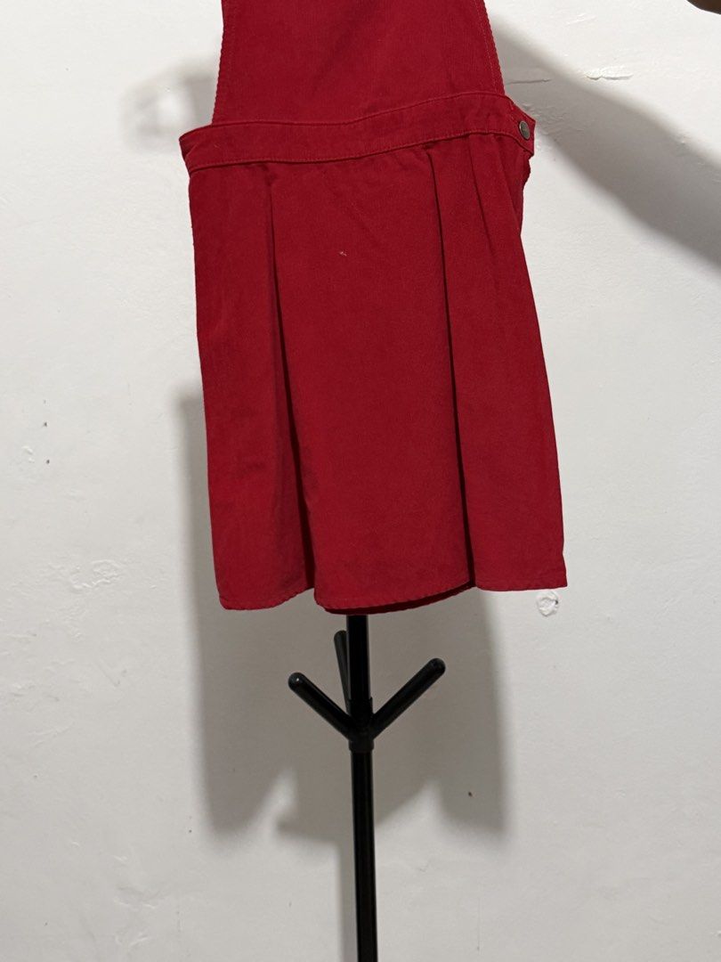 Red Corduroy Overall Skirt (Category: Skirts) located in Mandaluyong City. Submitted by jdflores17 (Listing ID 1470455699, Image 1). Description: - Color: Bright red / deep crimson - Material: Soft textured corduroy - Design: Pleated front with structured waistband and side button closure - Length: Mini - Styling: Great for layering over basic tees and sweaters.