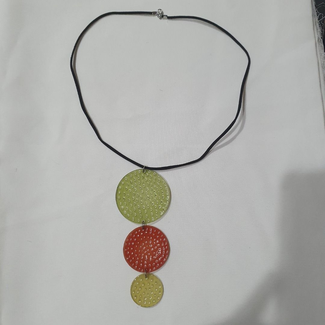 Resin Statement Pendant Necklaces (Category: Necklaces) located in Caloocan City. Submitted by mma_222 (Listing ID 1470398902, Image 2). Description: - Style: Set of 2 statement necklaces on black cords - Design 1: Three textured hanging circles in green, red, and yellow - Design 2: Oval pendant featuring white floral motifs and round dots on a translucent base - Material: Chunky yet lightweight resin - Perfect for: Elevating your everyday casual