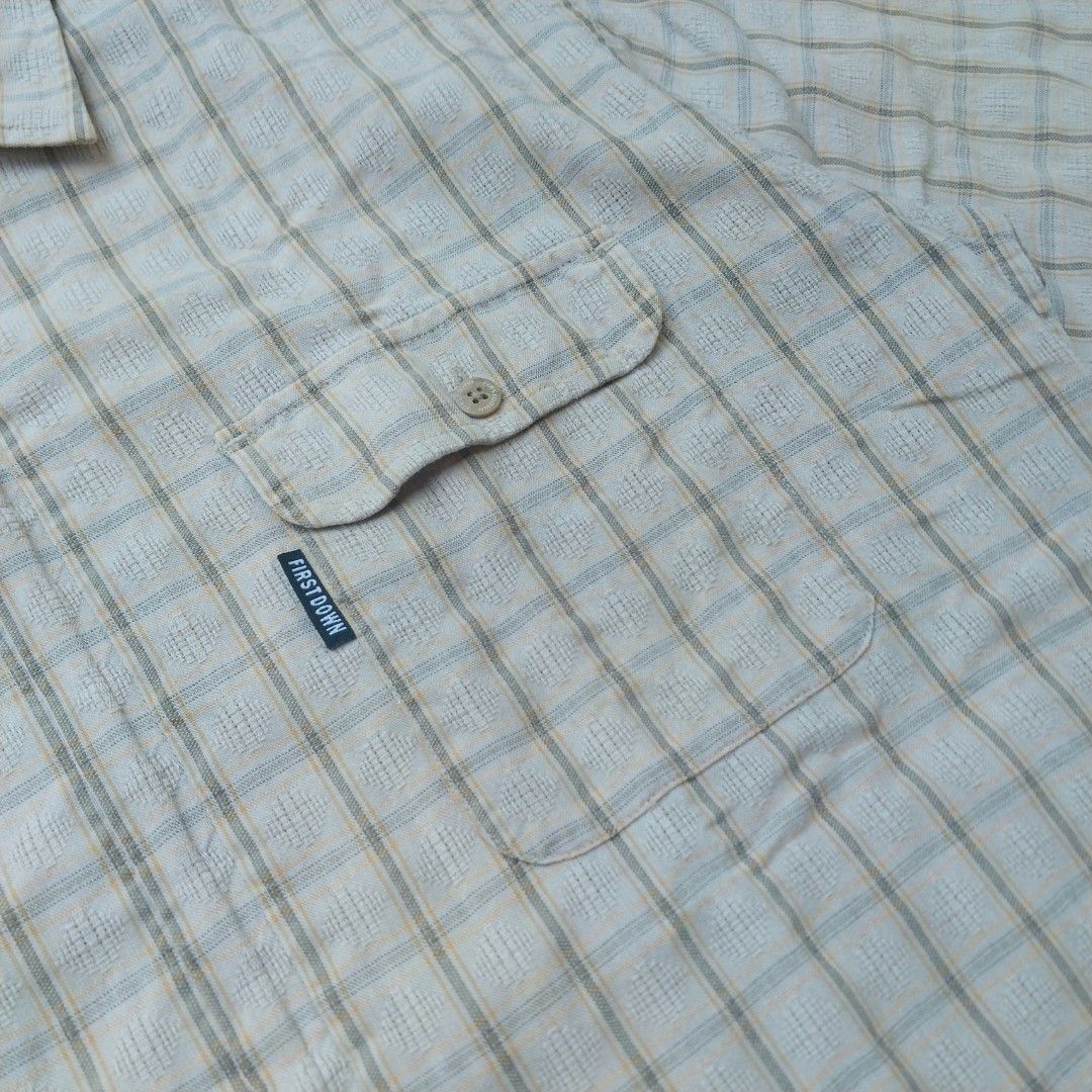 Retro Style Plaid Zip-Up Short Sleeve (Category: Tshirts & Polo Shirts ) located in Cavite. Submitted by spinfits (Listing ID 1470428767, Image 3). Description: - Brand: First Down - Size: Medium - Color/Pattern: Cream with a subtle plaid check - Closure: Modern full-zipper front instead of standard buttons - Pockets: Single chest pocket with button flap and woven logo tag - Fabric: Premium textured feel - Condition: Excellent Size: S-M (Width: 2